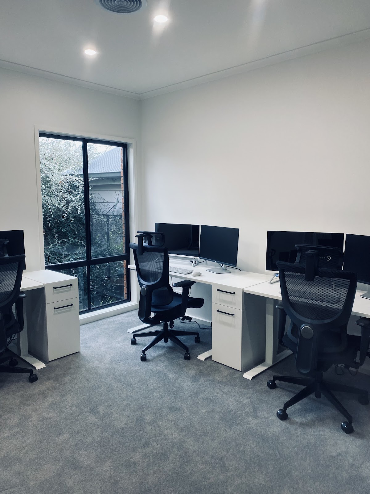 White office desks with pedestal drawers in a bright office